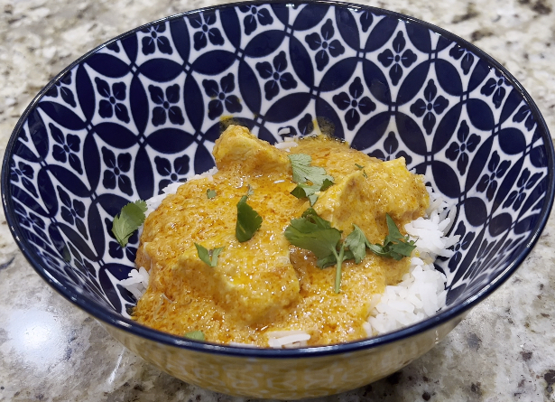 Katie's Chicken Curry on a bed of rice, garnished with cilantro